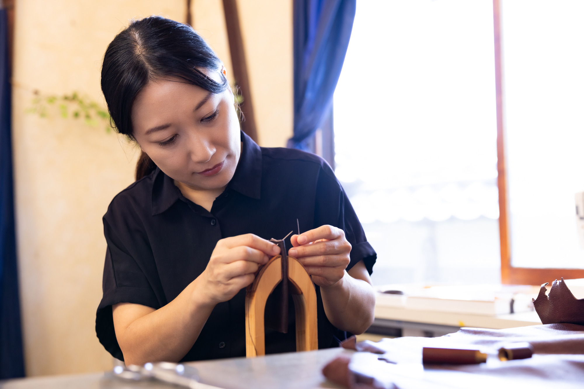 革から脂を取り除いて下処理後、専門業者でなめしへ。その後、分厚い革はミシンや針を2本使いで手縫いで縫製します。